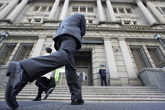 A man walks towards the Bank of Japan building in Tokyo.