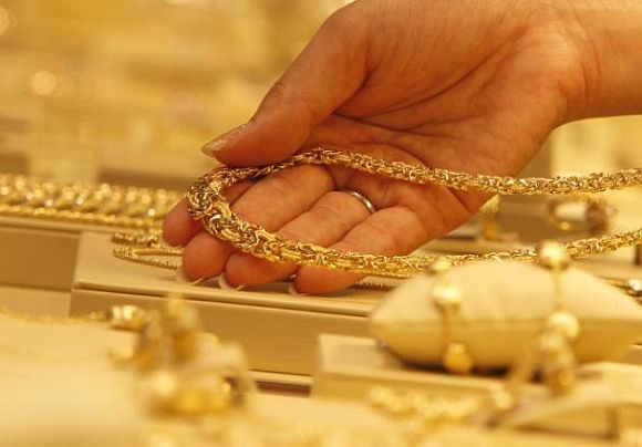 An employee displays a gold necklace.
