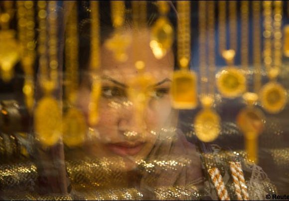 A woman looks at jewellery while shopping at a bazaar.