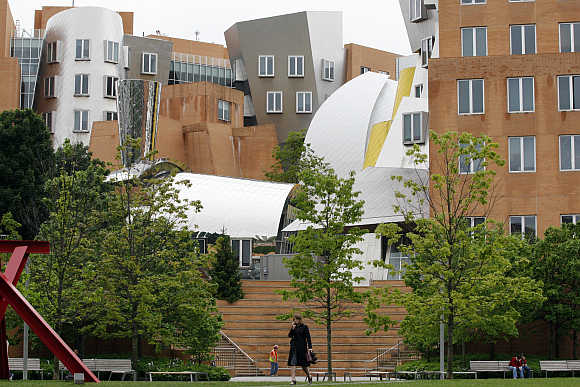 A woman walks across the campus at the Massachusetts Institute of Technology in Cambridge, Massachusetts.