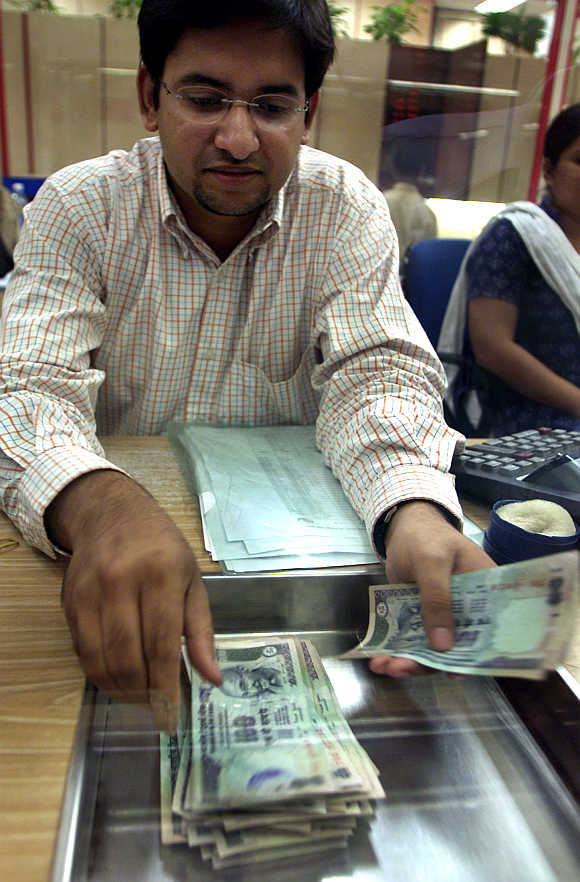 A forex dealer counts rupee notes in Mumbai.