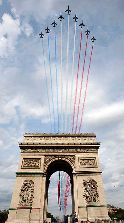 Fighter planes stream the red, white and blue colours of the French flag over Paris's Champs Elysees during the annual Bastille Day celebrations.