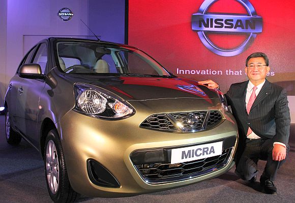 Kenichiro Yomura, President of Nissan India, poses with the new Nissan Micra, in Mumbai.