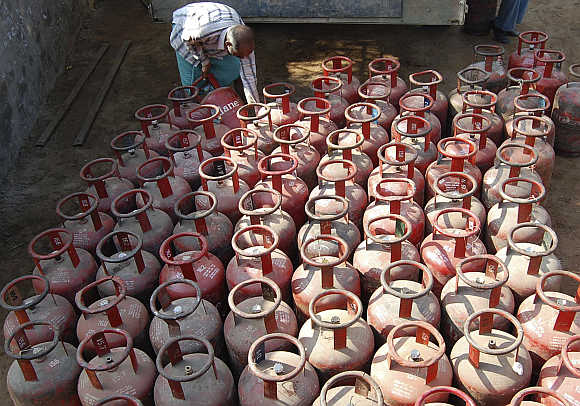 A vendor loads empty Liquefied Petroleum Gas cylinders in Mathura.