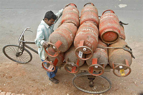 A worker loads Liquefied Petroleum Gas cylinders in Kolkata.