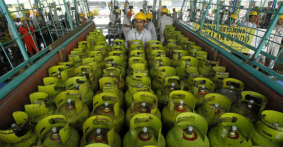 Workers upload LPG cylinders before sending to customers in Jakarta, Indonesia.