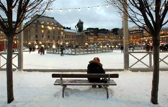 A visitor to the Kungstradgarden ice rink puts on her skates in downtown Stockholm.