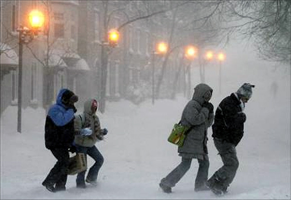 People walk in the street during a snow storm of Quebec City.