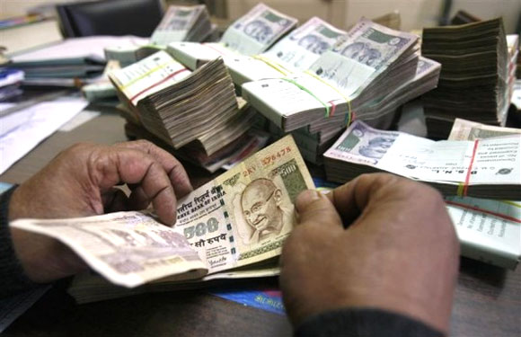 Rupee drops to record low of 61.21, recovers 