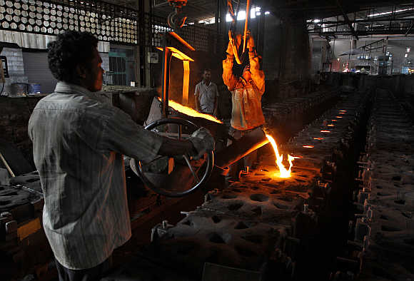 Workers tend to a furnace at a steel factory in the outskirts of Coimbatore.