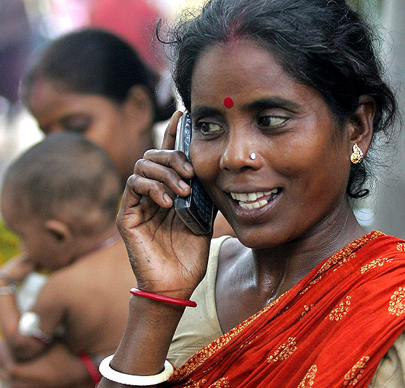 Tulsi Prasad, an Indian slum dweller, uses a mobile phone.