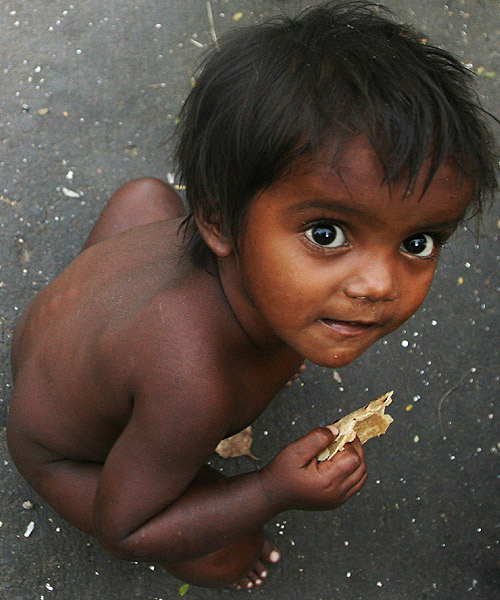 A boy eats roti at a slum in Mumbai. 