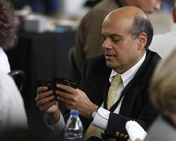 Ajit Jain plays a game of bridge during Berkshire Hathaway Shareholders annual meeting in Omaha, Nebraska.