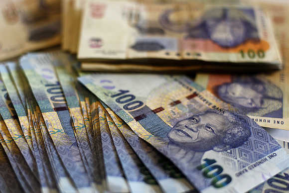 South African bank notes featuring an image of former president Nelson Mandela are displayed at an office in Johannesburg.