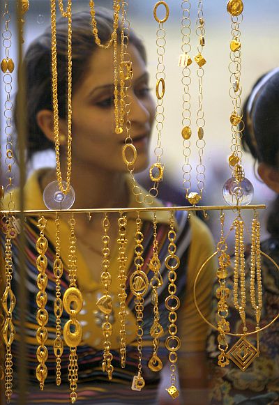 A woman looks at gold jewellery.