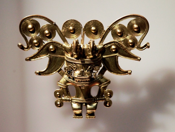 A piece of a gold breastplate in the shape of a bat-like man, is displayed at the exhibition.
