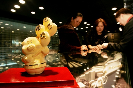 An ornament in the shape of a pig made of .9999 fine gold is displayed for sale at a jewellery store in Hong Kong.