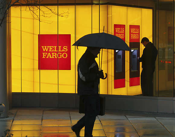 A man walks past a Wells Fargo branch in Washington, DC.