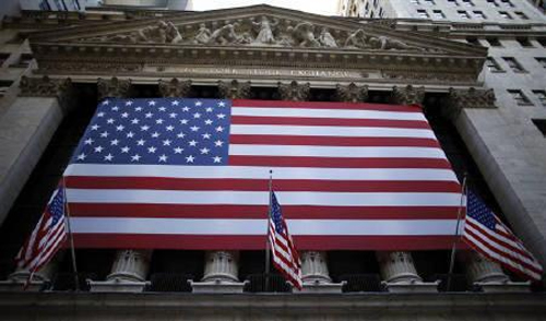 U.S. flags hang on the facade of the New York Stock Exchange.