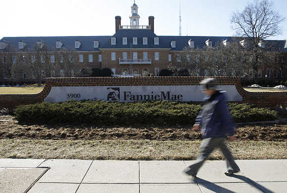 A woman walks past the Fannie Mae headquarters in Washington, DC.