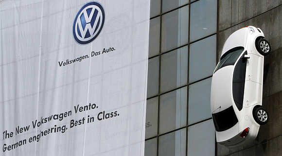 Volkswagen's Vento car hangs on display from a building during its launch in New Delhi.