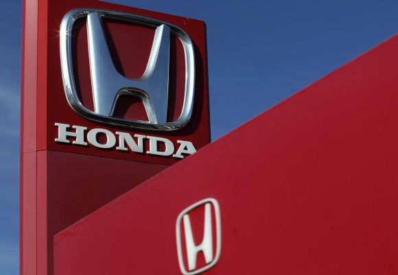 The Honda logo is seen on the forecourt of a car dealer.