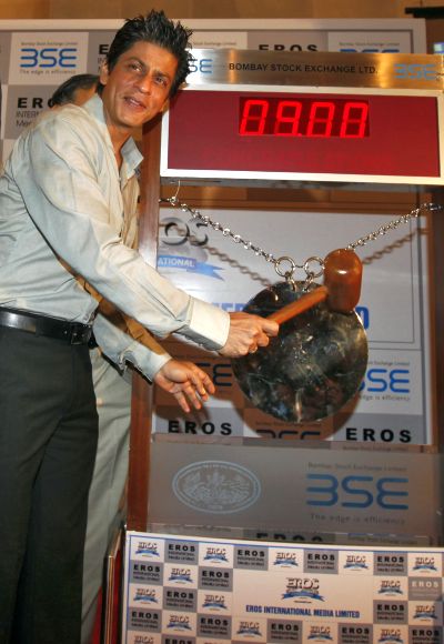 Bollywood actor Shah Rukh Khan poses before hitting the ceremonial gong during his visit to the Bombay Stock Exchange building.