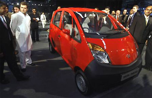 A file photo of Rahul Gandhi (L in white) next to a Tata Nano after its launch at the 9th Auto Expo in New Delhi on January 10, 2008.