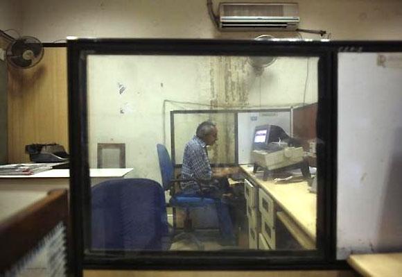 S R Gaur, 55, works inside the Central Telegraph Office in New Delhi July 10, 2013.