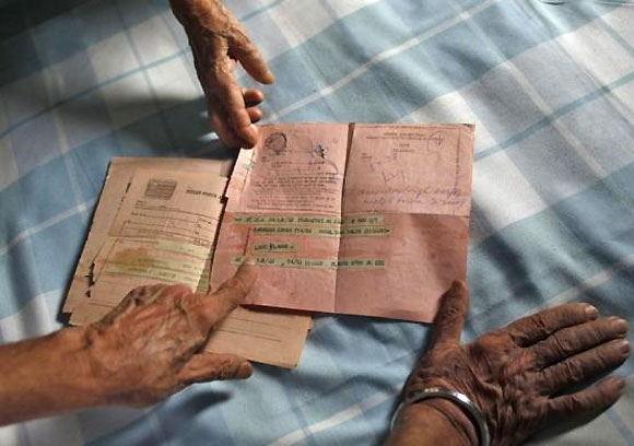 Surjeet Kaur, 77, displays a telegram which was sent to her son by her daughter-in-law in 1978, inside her house in New Delhi July 9, 2013.