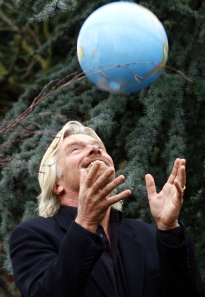 Airline tycoon Richard Branson throws a globe in the air.
