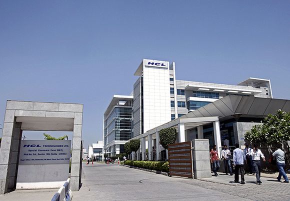 People walk in front of the HCL Technologies Ltd office at Noida.