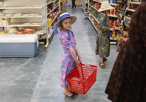 A girls holds a basket at a supermarket at the Mennonite community of Buenos Aires in the northern Mexican state of Chihuahua.