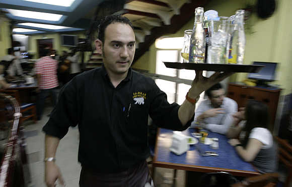 A waiter carries drinks in La Polar Bar in Mexico City.