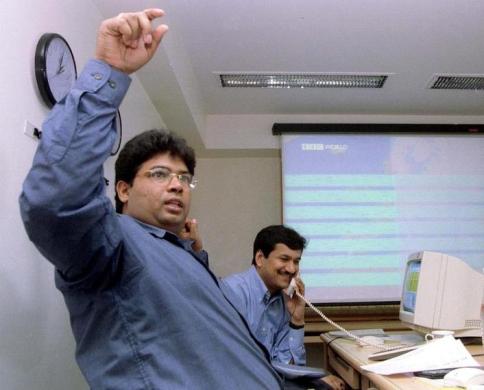 Stock brokers trade in Mumbai, July 5, 1999.