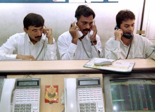 Stock brokers trade at a brokerage firm in Mumbai, July 12.
