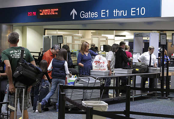 Passengers line up at a security checkpoint operated by the Transportation Security Administration at Fort Lauderdale-Hollywood International Airport in Fort Lauderdale, Florida.