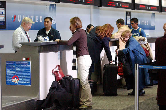 United Airlines employees assist customers at San Francisco International Airport in San Francisco, California.