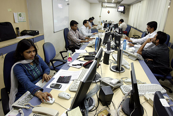 Brokers trade on their computer terminals at a stock brokerage firm in Mumbai.