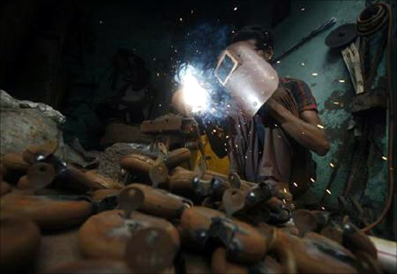 An employee works inside a small-scale locks manufacturing factory at Aligarh district in Uttar Pradesh.