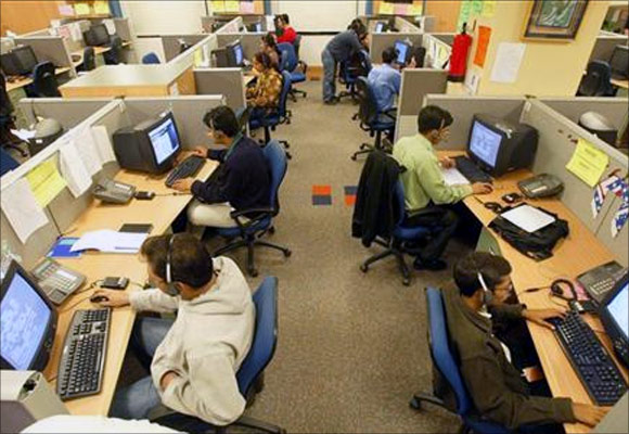 Indian engineers attend to calls from abroad inside a call centre in Gurgaon on the outskirts of New Delhi.