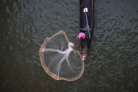 A fisherman casts his net into the Kathajodi River in Cuttack district, about 25km from Bhubaneswar.