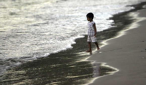 A child walks on a beach in Port Blair.