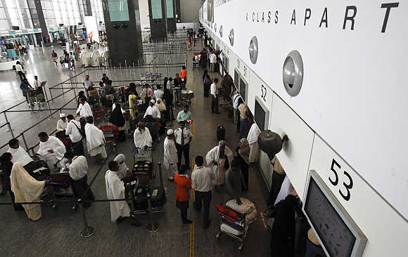 Passengers wait at the check-in hall at Bangalore International Airport.