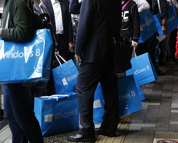 Customers wait to buy Microsoft's Windows 8 operating system outside an electronics store at the Akihabara district in Tokyo, Japan.