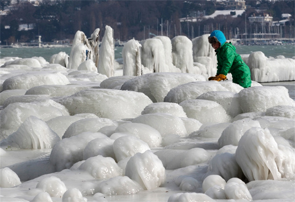 Children play in the icy aftermath of a snowstorm on the banks of Lake Leman in Geneva, Switzerland.