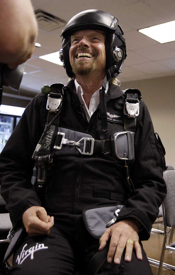  Richard Branson shares a laugh during pre-flight training to fly on Virgin Mother Ship Eve, White Knight Two, at Wittman Field, site of the Experimental Aircraft Association Convention in Oshkosh, Wisconsin, United States.