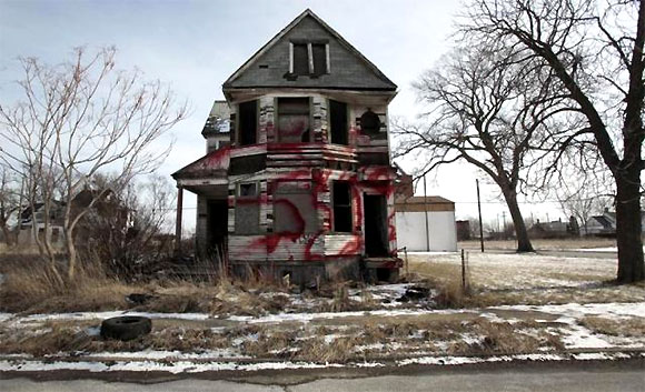 A vacant and blighted home, covered with red spray paint, sits alone in an east side neighbourhood once full of homes in Detroit.