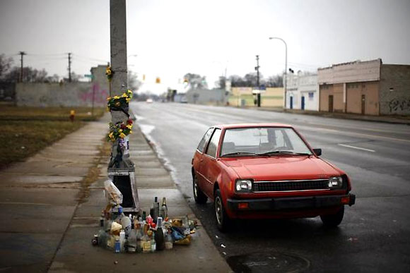 A car is seen next a memorial in Detroit.