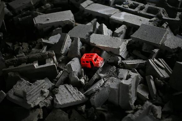 A child's toy is seen in a pile of concrete blocks inside the abandoned and decaying Packard Motor Car Manufacturing Plant.